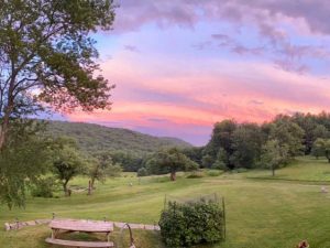View from Warner Hill of a lawn and hills at sunset